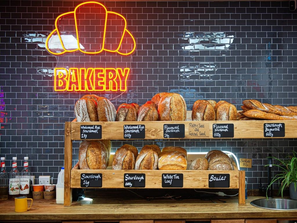 Underground bakery Leeds counter with orange neon brakery sign.